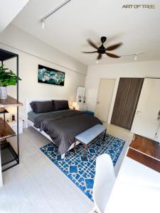 峇都丁宜By The Sea Beachfront Designer Suites Penang - Managed by Art of Tree的一间卧室配有一张床和吊扇