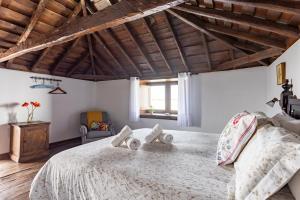 FasniaVilla Rural La Zarza by Sunkeyrents的一间卧室设有一张带木制天花板的大床。