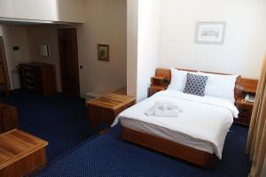 萨拉热窝Hotel Brass的酒店客房,配有带毛巾的床