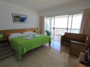拉迪格岛法国海滨玛丽公寓酒店的一间卧室配有绿床和毛巾