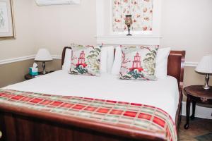 GrotonBenn Conger Inn的一间卧室配有带白色床单和枕头的床。