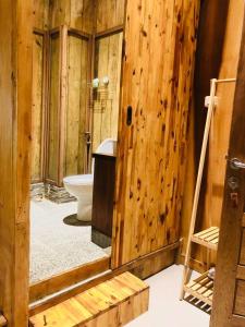 班达亚齐stay KULTURA的一间带卫生间和木墙的浴室
