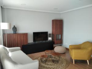 桑亨霍Chalet con vista a las Islas Cíes的客厅配有白色沙发和黄色椅子