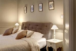 布鲁日布鲁日住宿加早餐旅馆的一间卧室配有一张床和两盏灯,墙上挂着图片