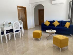 乌姆苏克La casa blanca的客厅配有蓝色的沙发、桌子和椅子