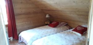 若西耶Chalet cocody jacuzz的木墙客房的两张床