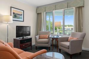 奥甘奎特斯帕哈克海滨度假汽车旅馆的客厅配有沙发、椅子和电视
