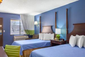 谢拉维斯塔Rodeway Inn near Ft Huachuca的蓝色客房 - 带两张床和椅子
