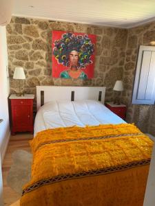 蒙桑图Casa da Avó Maria的一间卧室配有一张壁画床