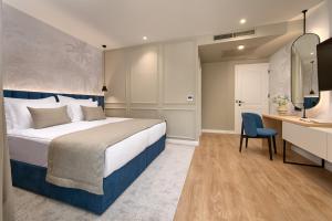 赫瓦尔Hotel Moeesy, Blue & Green Oasis的酒店客房配有一张床、一张桌子和一把椅子。