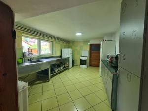 布什泰尼CASA FLORESCU的厨房配有白色家电和黄色瓷砖地板。