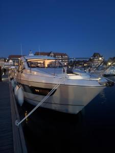 多维尔Puissance, Elegance et Style, Yacht à Deauville的夜间停靠在港口的白色船只
