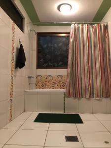 苏克雷Belle Ville的带淋浴帘和窗户的浴室