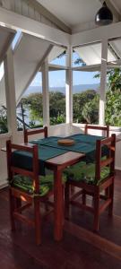 萨武萨武Gingerbread Cottage and Studio Fiji的一间带桌子和两把椅子的用餐室