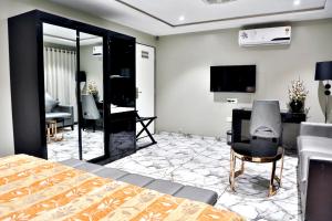 苏拉特Hotel Kings Heritage Surat的一间卧室配有一张床、一张书桌和一台电视