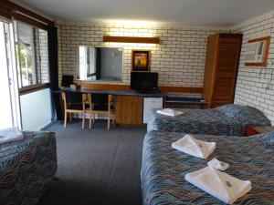 GayndahGayndah A Motel的酒店客房设有两张床和电视。