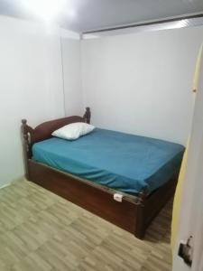 莱蒂西亚ApartaRefugio EL RETIRO VERDE 2的一间卧室配有一张带蓝色床单的床