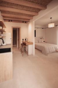 阿菲托斯Om Living Afitos的厨房以及带1张床和1张桌子的卧室