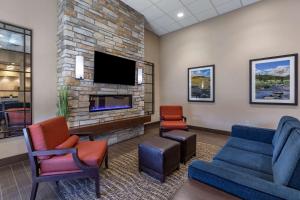 比尤特Comfort Inn Butte City Center I-15 - I-90的一间配有沙发、椅子和电视的等候室