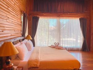 柴老海滩蓝调河度假酒店的一间卧室设有一张床和一个大窗户