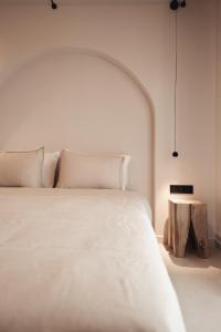 阿菲托斯Om Living Afitos的卧室配有一张白色的大床和一张桌子