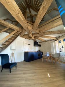 BeauvilliersFerme de Mesangeon的客厅设有木制天花板和家具。