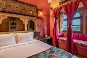 斋沙默尔菲夫酒店的卧室设有红色的墙壁、一张床和窗户