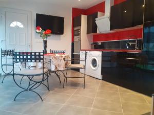 蒙达迪Villa Piscine的厨房配有桌椅和洗衣机。