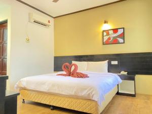 珍南海滩安贞别墅酒店的一间卧室配有一张带两个蛇床的卧室