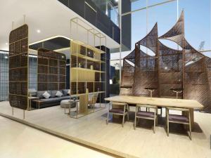 马卡萨Mercure Makassar Nexa Pettarani的大楼内带桌椅的用餐室