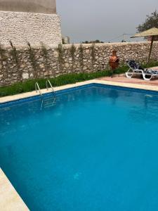 索维拉Riad Aïcha Addi - Poolside - Traditional Moroccan的围栏旁的大型蓝色游泳池