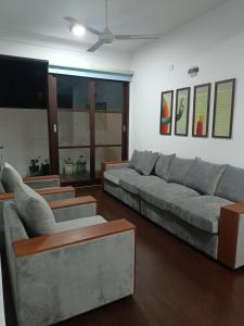 帕讷杜勒Villa Suyara的客厅配有灰色的沙发和桌子