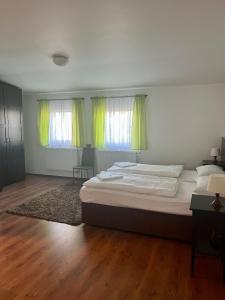 马达伯乐斯拉夫姆拉达博莱斯拉夫运动酒店的一间卧室配有一张带绿色窗帘和地毯的床