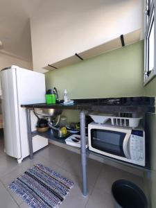 乌巴图巴CHALES DO BONA MARANDUBA的厨房配有微波炉和冰箱。