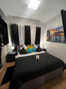 亚琛格兰纳斯酒店的一间卧室配有一张大床,提供黑色和黄色枕头