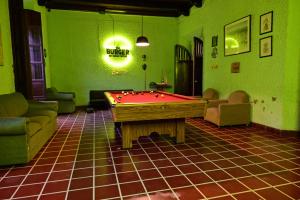 圣安娜Ricks hostel Santa Ana的绿墙客房内的台球桌