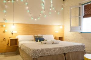 塞维利亚The Nomad Hostel&Pension的一间卧室配有一张大床和灯光