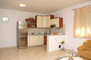 苏佩塔尔Apartments by the sea Supetar, Brac - 4274的厨房配有不锈钢冰箱和白色橱柜