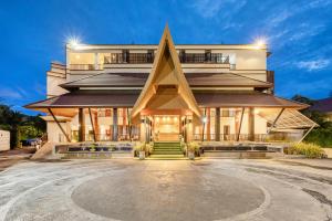 邦涛海滩Hotel COCO Phuket Bangtao - SHA Extra Plus的金字塔形外墙和庭院的铝制建筑