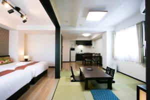 东京Minn Machiya的一间卧室配有一张床铺和一张桌子,还设有一间厨房