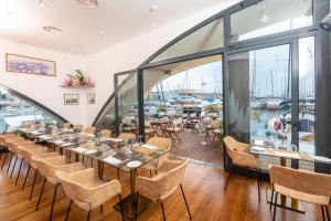热那亚Locanda da Toto的一个带桌椅的用餐室和一个码头