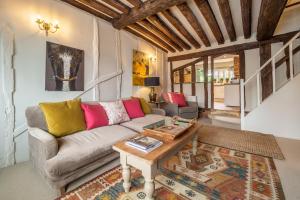 萨德伯里Utterly divine romantic retreat in brilliant village - Tudor Cottage的客厅配有沙发和桌子