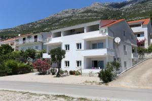 库希斯特Apartments by the sea Kuciste - Perna, Peljesac - 4545的路边的白色公寓楼