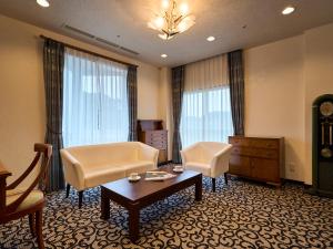 佐世保Hotel Flags Kuju Kusima的客厅配有沙发、椅子和桌子