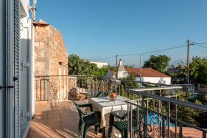 ArónionAroni Cretan comfortable house - Hamam suites Aroni的阳台的天井配有桌椅