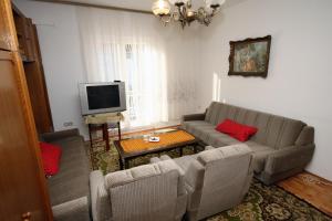 苏佩塔尔Apartments with a parking space Supetar, Brac - 6035的带沙发和电视的客厅