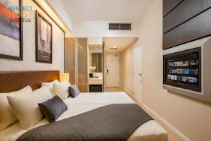 八打灵再也Centrestage Petaling Jaya by Perfect Host的配有一张床和一台平面电视的酒店客房