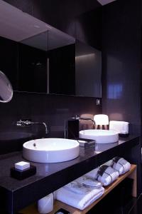 卡塞雷斯Atrio Restaurante Hotel 5 Estrellas - 3 Llaves Michelan的一间带两个盥洗盆和大镜子的浴室