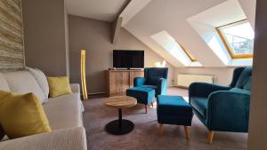 布尔格Hotel Zum Leineweber的客厅配有蓝色椅子和电视