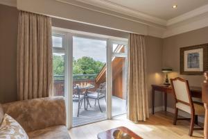 莱克斯利普庭院酒店的客厅设有滑动玻璃门,可通往阳台